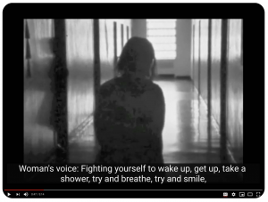 A black and white screenshot from a Youtube video of a person in silhouette in a long hall.