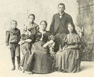 Portrait of Booker T. Washington and his family, Margaret Murray Washington to his right