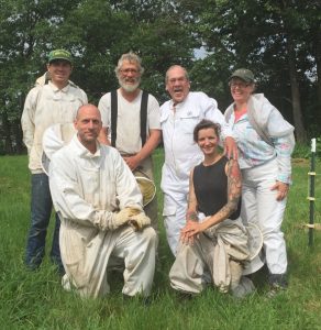 Kirk Webster stands in field with Ang Roell and others in a field