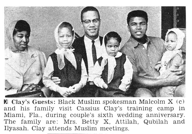 A newspaper photograph, with caption, of Malcolm X seated and posing with his wife and three children and friend. The caption reads: "Clay's Guests: Black Muslim spokesman Malcolm X (center) and his family visit Cassius Clay's training camp in Miami, FLA., during couple's sixth wedding anniversary. The Family are: Mrs. Betty X, Attilah, Qubilah and Ilyasah. Clay attends Muslim meetings.