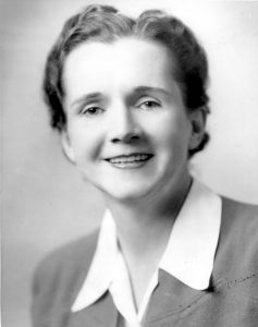 Black and white photo of a smiling caucasian woman