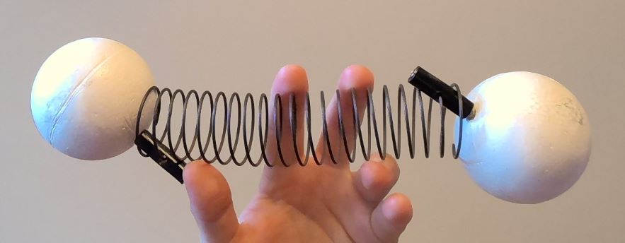 A model of diatomic oxygen: two atoms connected by a spring.