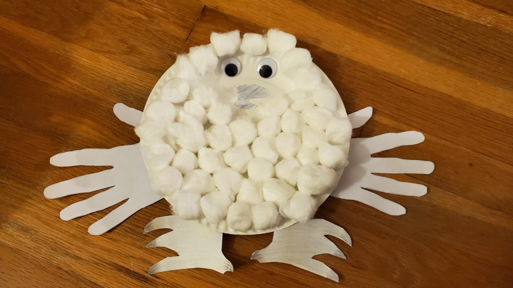 Chick made from paper plate, handprint wings, cutouts for feet and beak, google eyes, and cotton balls for down.