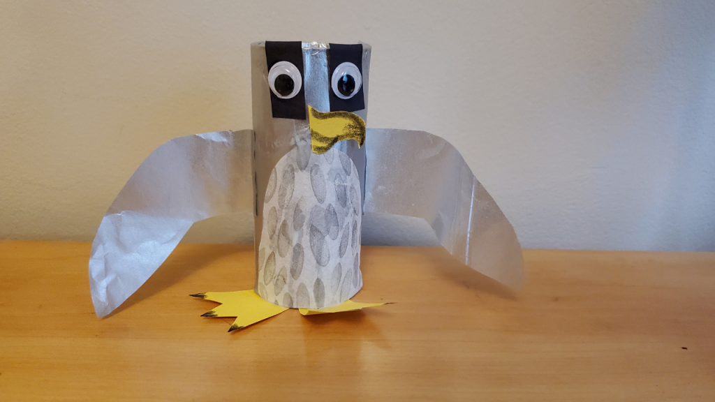 Toilet paper roll decorated to look like peregrine falcon.